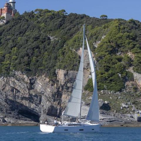 a small boat in a body of water with a mountain in the background