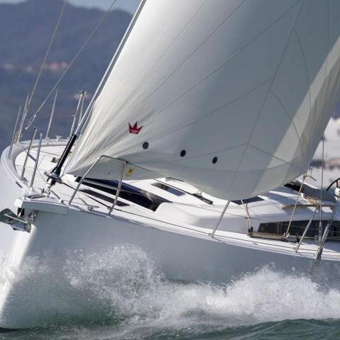 a man riding on the back of a boat in the water