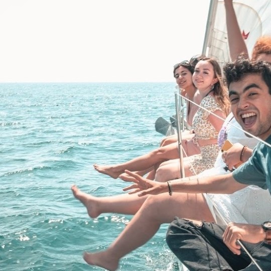 a person riding on the back of a boat in a body of water
