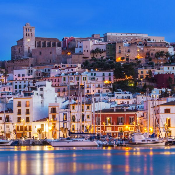 a small boat in a harbor in front of a building
