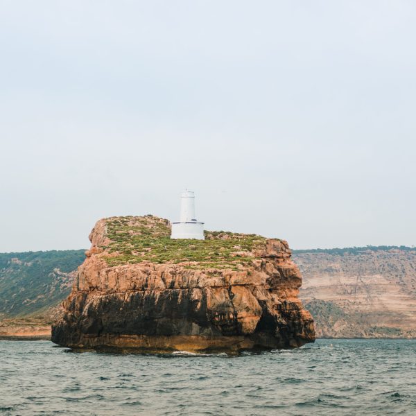 a large body of water with a mountain in the background