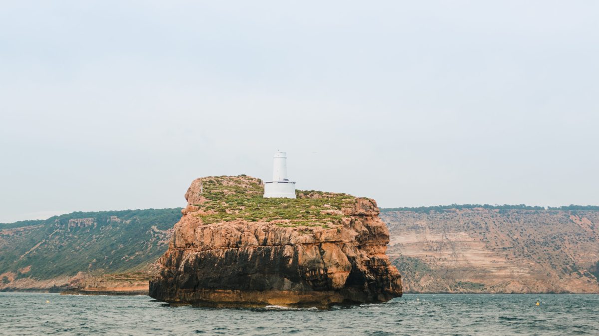a large body of water with a mountain in the background