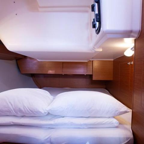 a bedroom with a bed and desk in a room